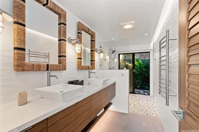 a bathroom with a double vanity sink a mirror and shower