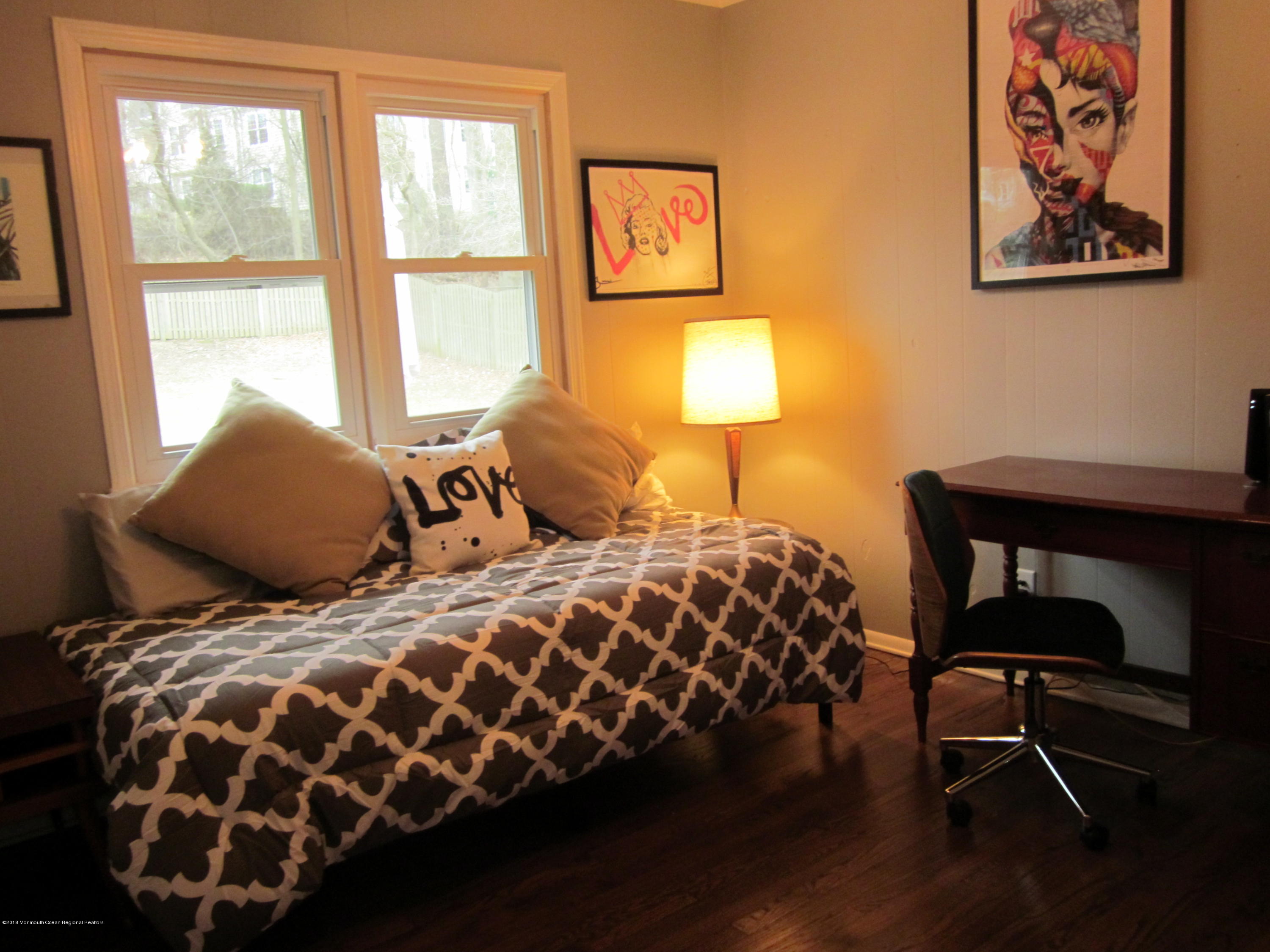 18 Crestview Drive Middletown, NJ 07748 - Photo 12 of 22 a bedroom with a bed and a lamp next to a window
