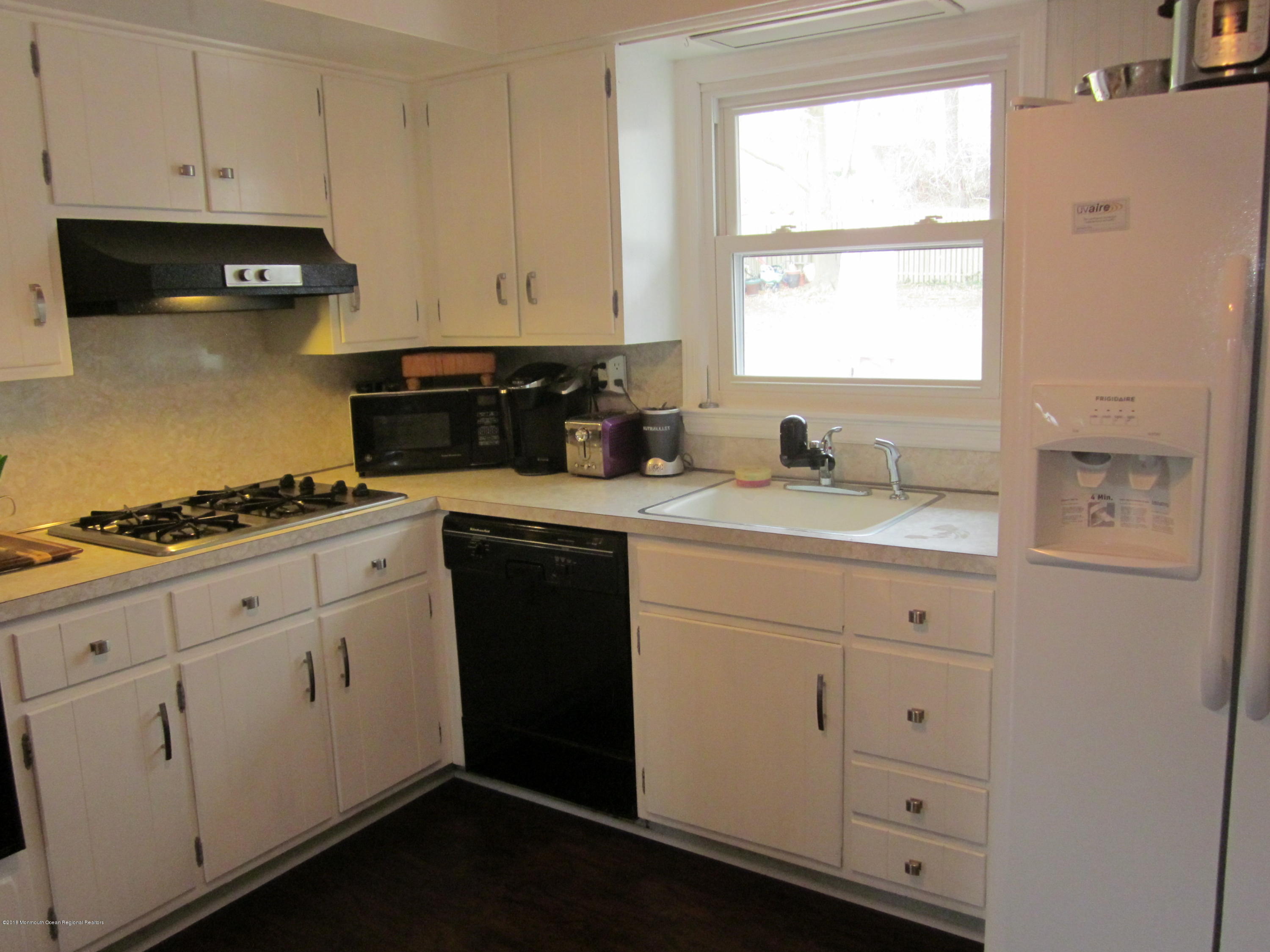 18 Crestview Drive Middletown, NJ 07748 - Photo 13 of 22 a kitchen with granite countertop white cabinets and white appliances