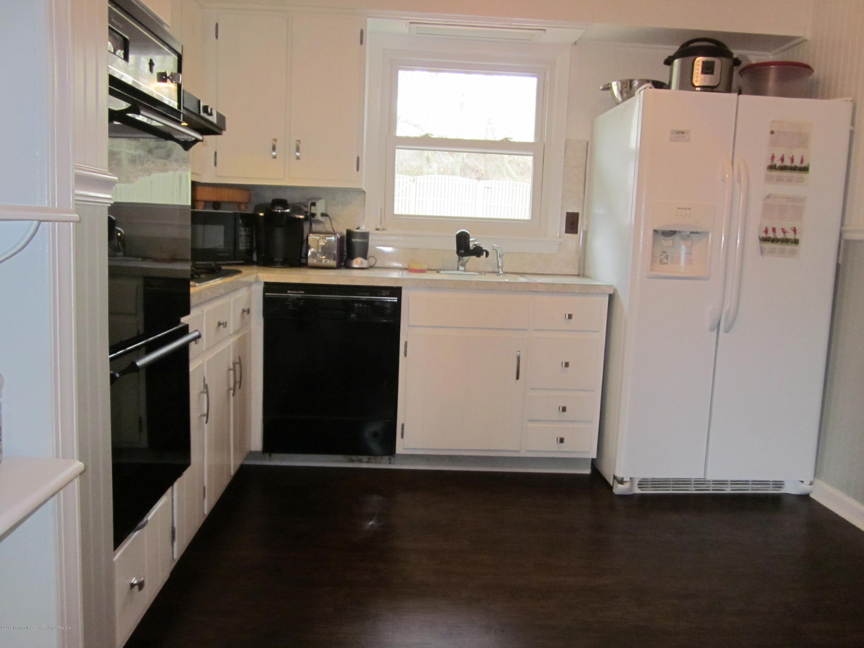 18 Crestview Drive Middletown, NJ 07748 - Photo 14 of 22 a kitchen with a refrigerator stove and white cabinets