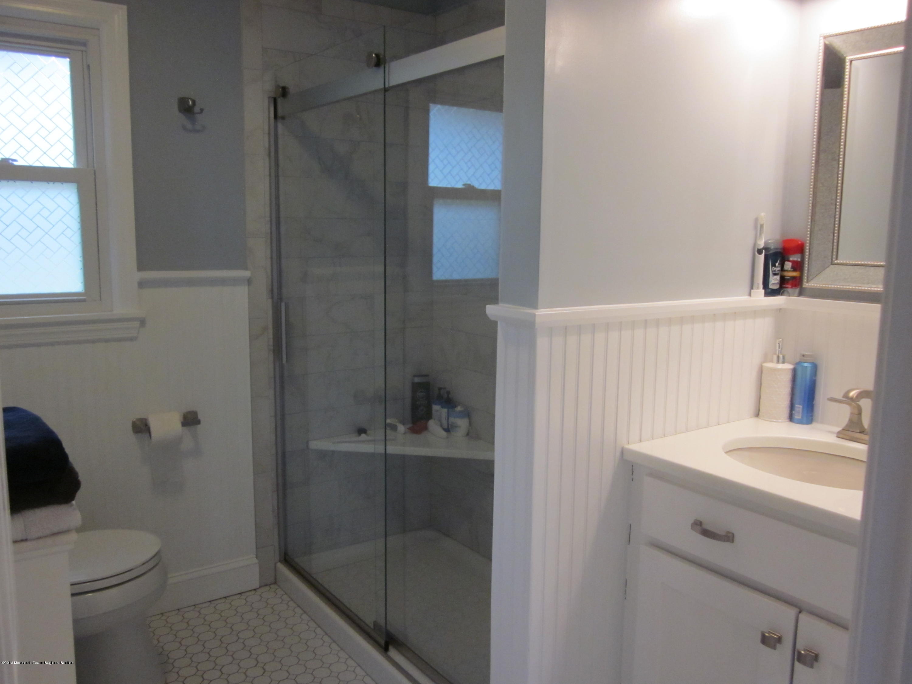 18 Crestview Drive Middletown, NJ 07748 - Photo 16 of 22 a bathroom with a sink a toilet and shower