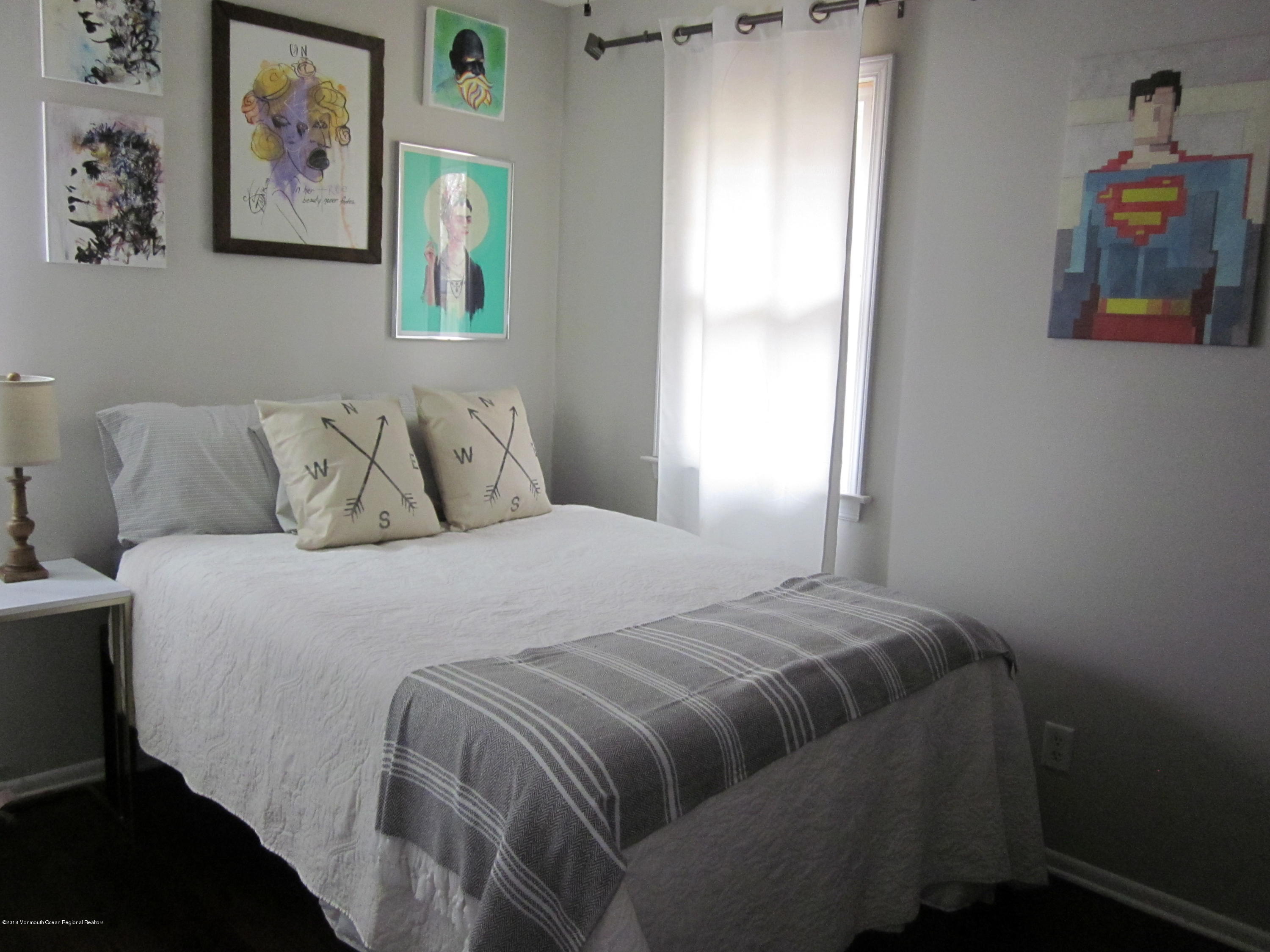 18 Crestview Drive Middletown, NJ 07748 - Photo 9 of 22 a bedroom with a bed and painting on the wall