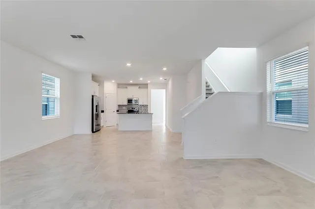 a view of a kitchen with a refrigerator and a window