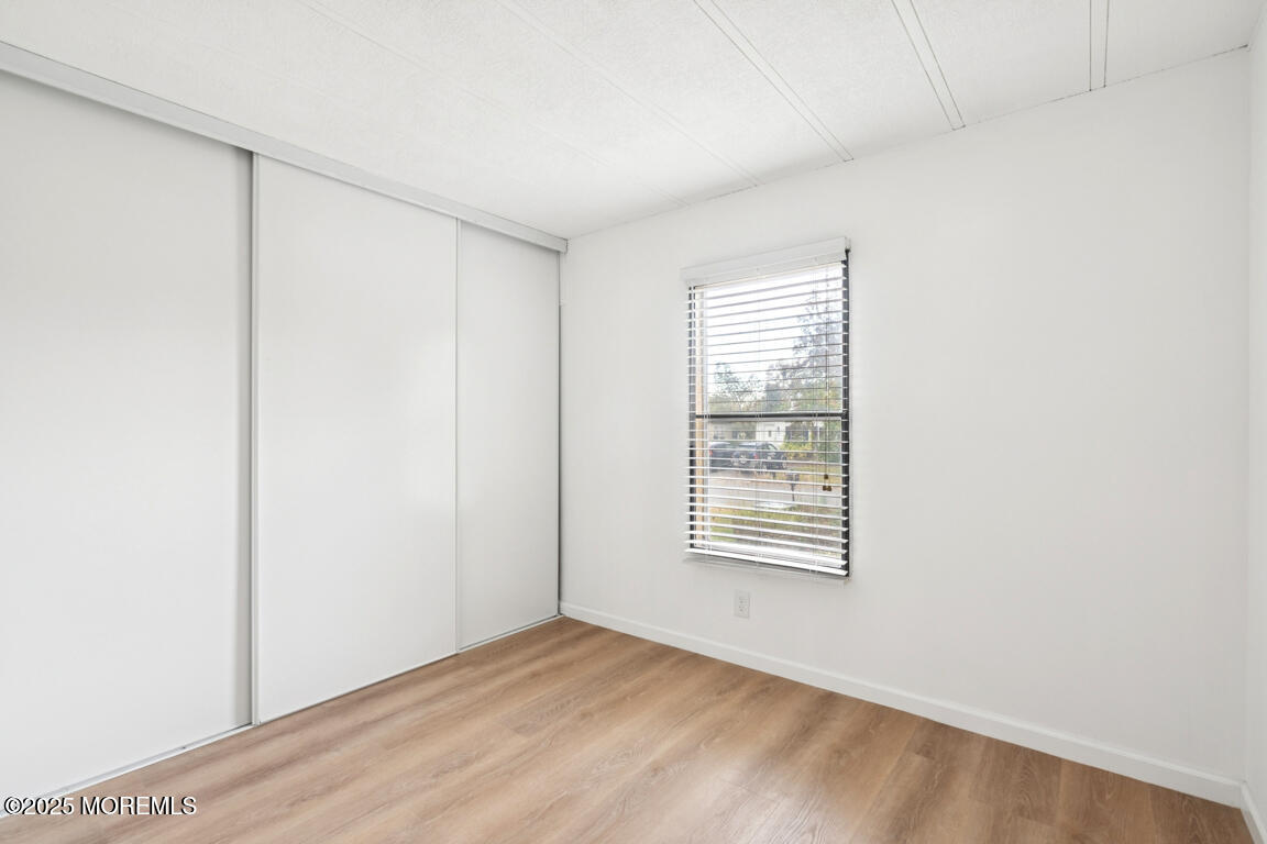 5 Fallow Drive Manalapan, NJ 07726 - Photo 15 of 24 a view of an empty room with wooden floor and a window