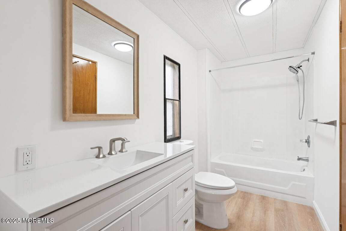 5 Fallow Drive Manalapan, NJ 07726 - Photo 20 of 24 a bathroom with a sink a toilet and shower