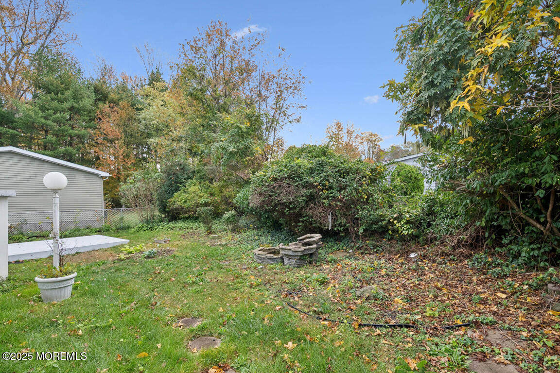 5 Fallow Drive Manalapan, NJ 07726 - Photo 21 of 24 a view of a garden with a bench