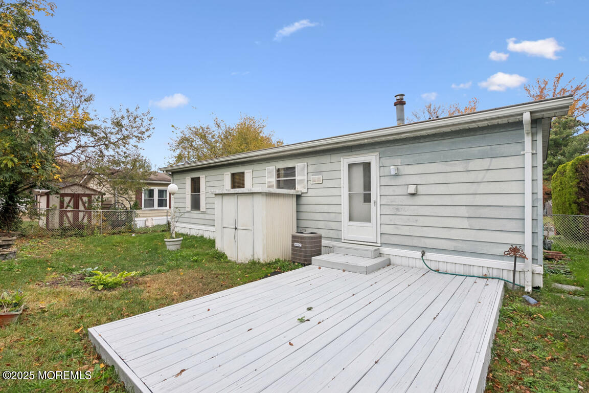5 Fallow Drive Manalapan, NJ 07726 - Photo 23 of 24 a backyard of a house with table and chairs