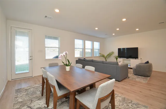 a view of a dining room with furniture and wooden floor
