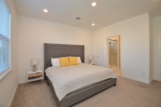 a bedroom with a bed and a night stand