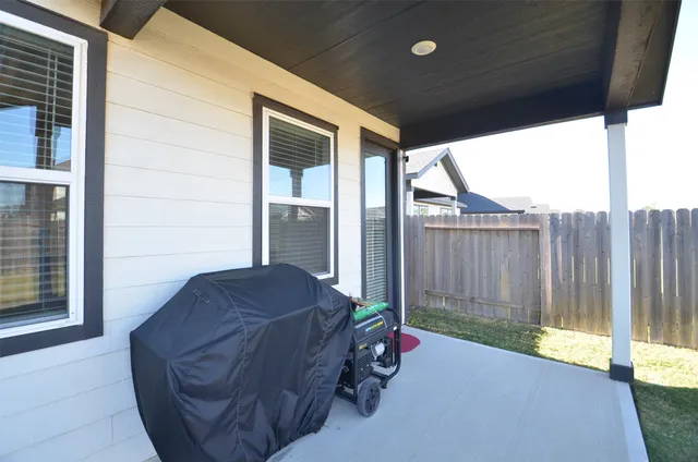 a view of backyard with tub and door