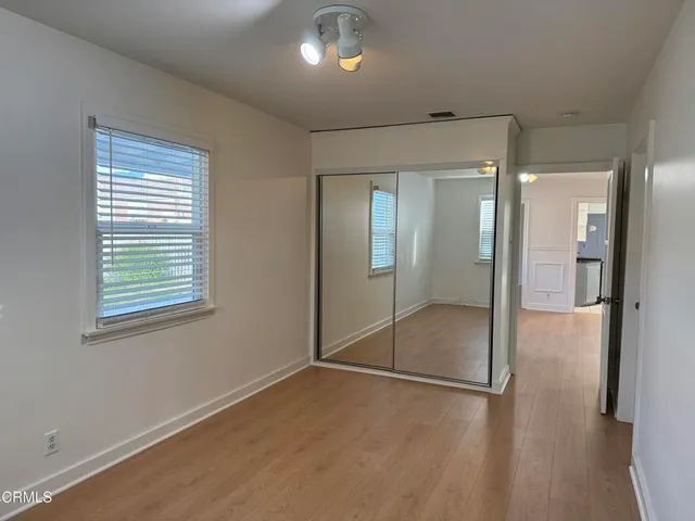 a bathroom with a glass shower door and a window