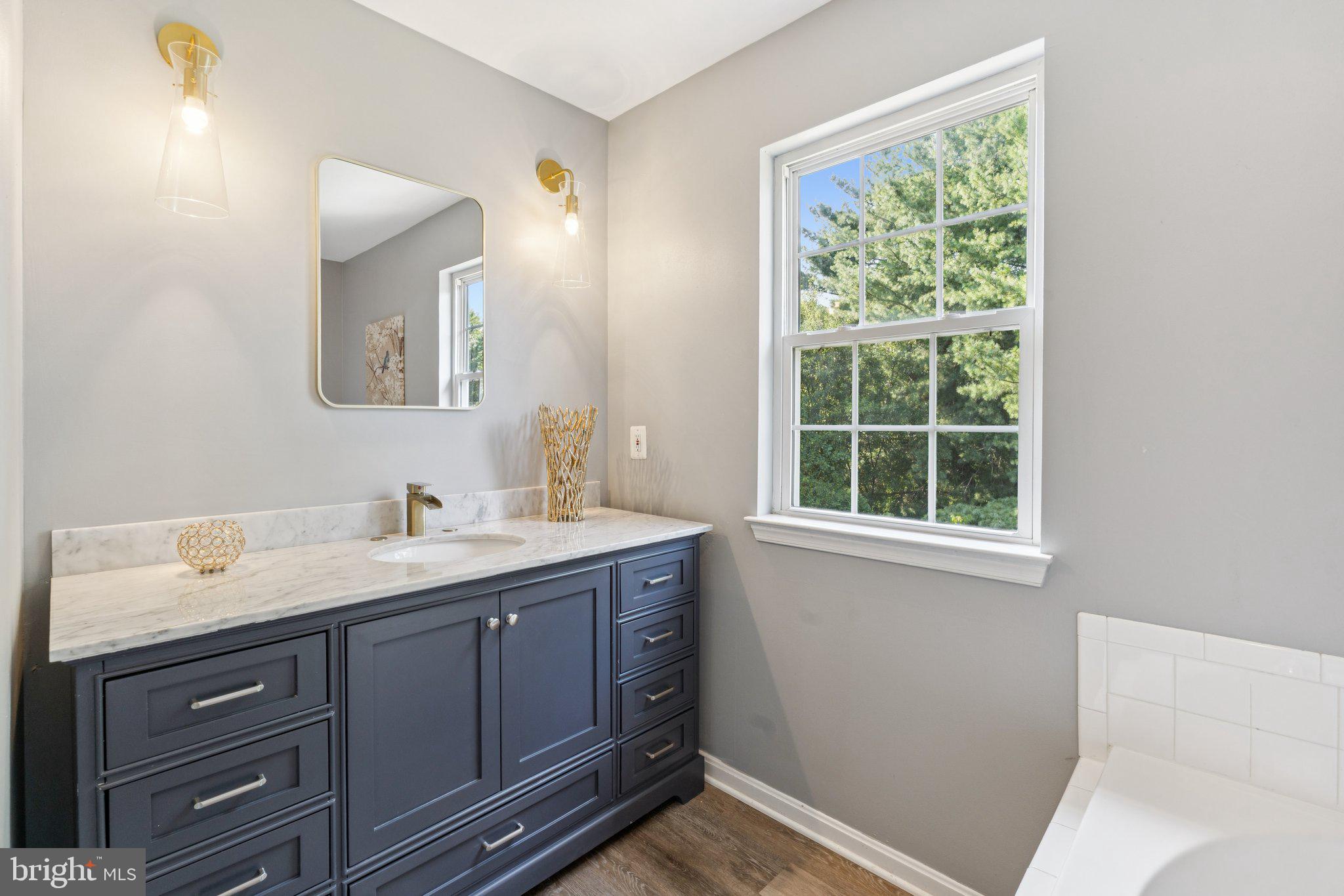 2050 Horace Ward Road Owings, MD 20736 - Photo 16 of 39 a bathroom with a granite countertop sink mirror and a window