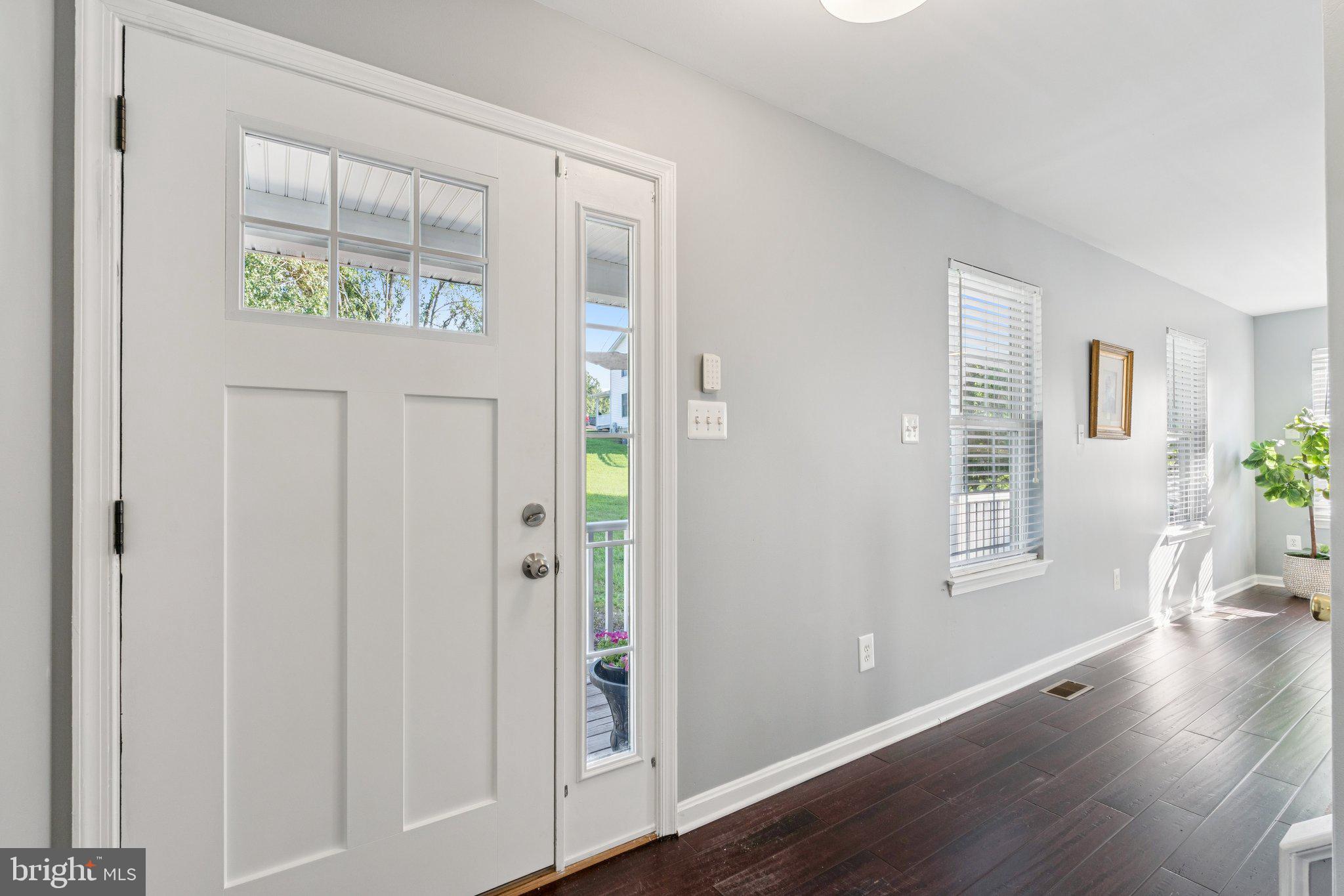 2050 Horace Ward Road Owings, MD 20736 - Photo 3 of 39 a view of an empty room with wooden floor and a window