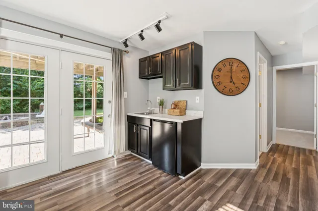 a view of a kitchen with fridge and wooden floor