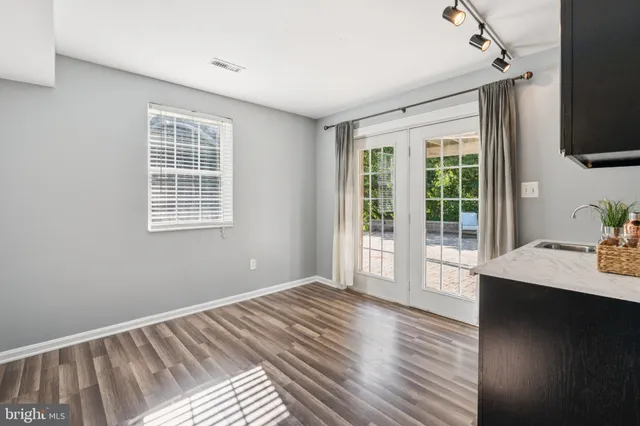 a view of a bedroom with wooden floor and balcony