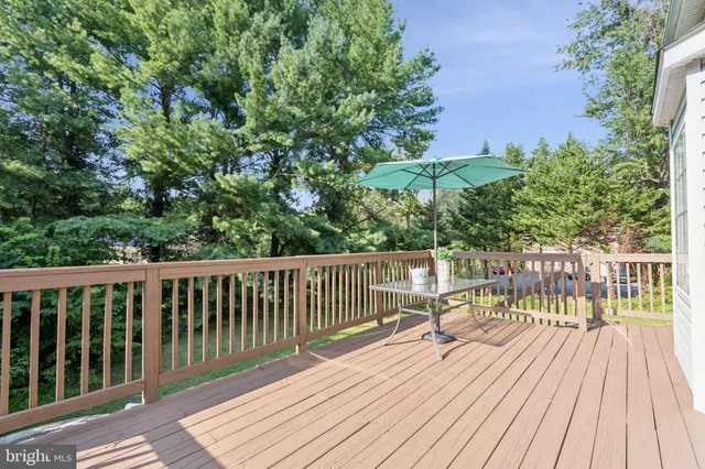 a view of balcony with wooden floor and fence