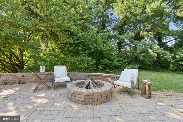 a view of a backyard with table and chairs potted plants and garden