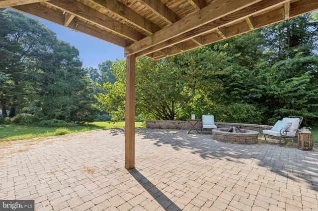 a view of a patio with table and chairs potted plants with wooden fence