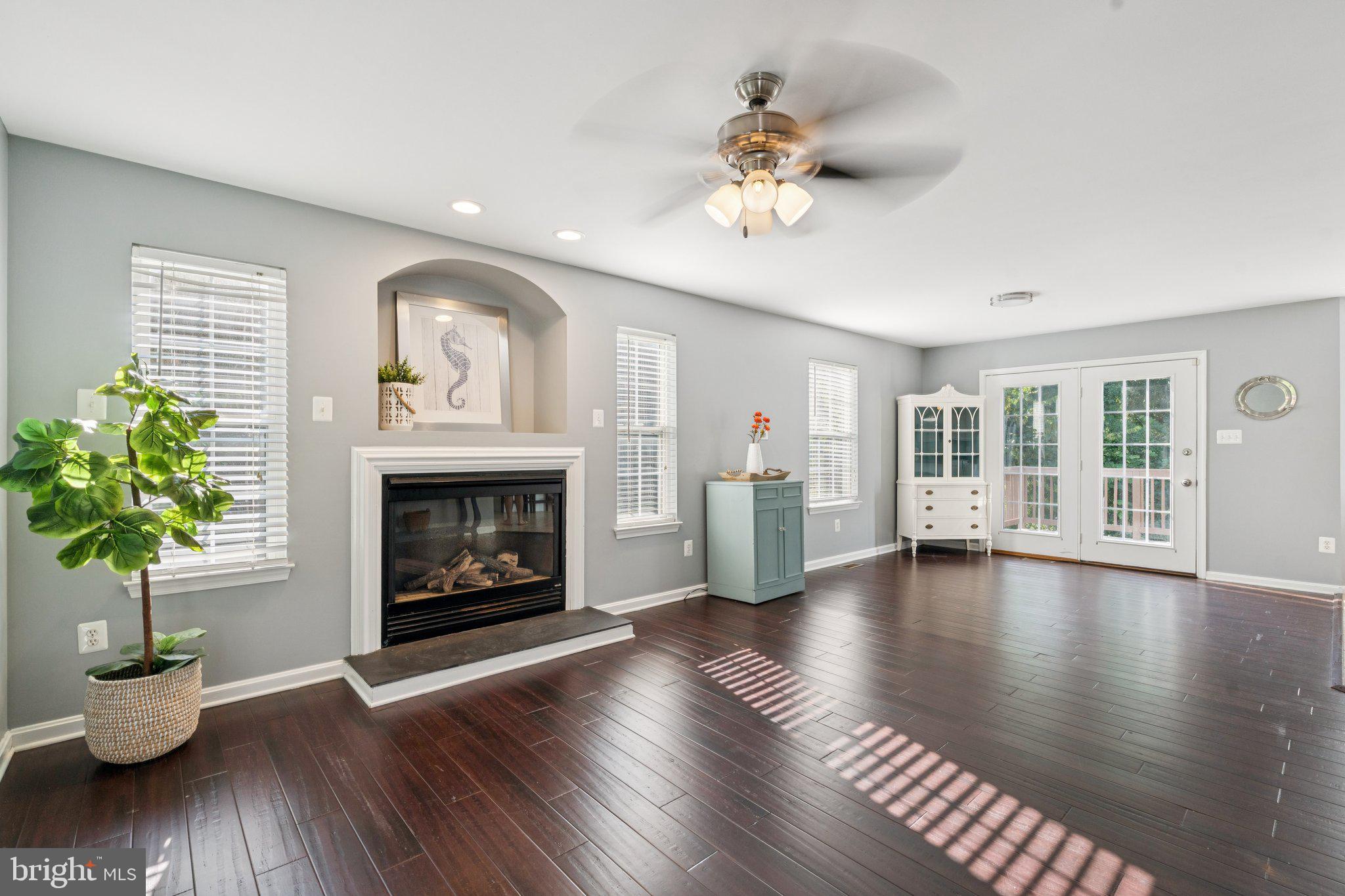2050 Horace Ward Road Owings, MD 20736 - Photo 4 of 39 a view of an empty room with wooden floor and a fireplace