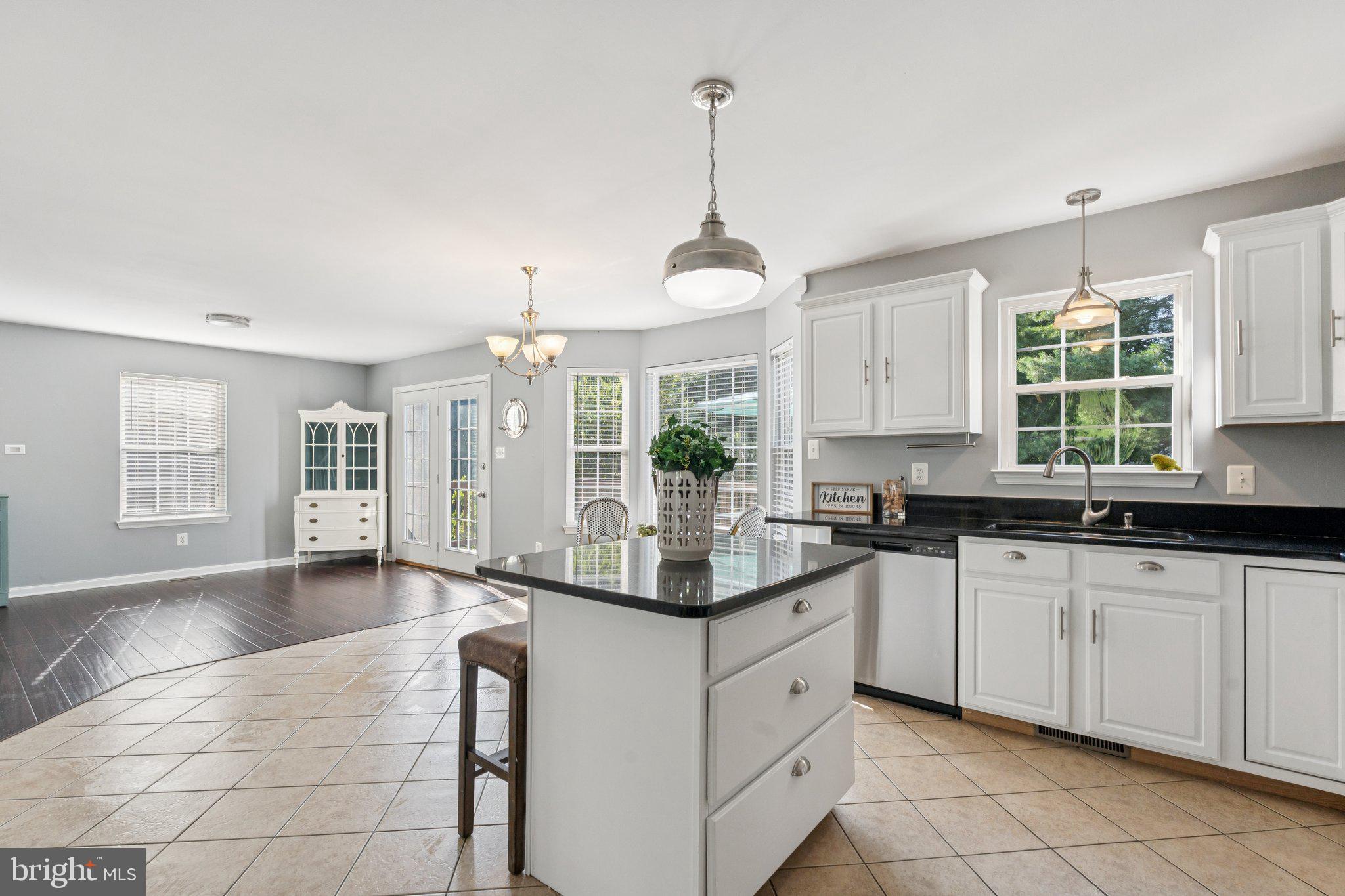 2050 Horace Ward Road Owings, MD 20736 - Photo 9 of 39 a kitchen with granite countertop white cabinets white appliances a sink and a window