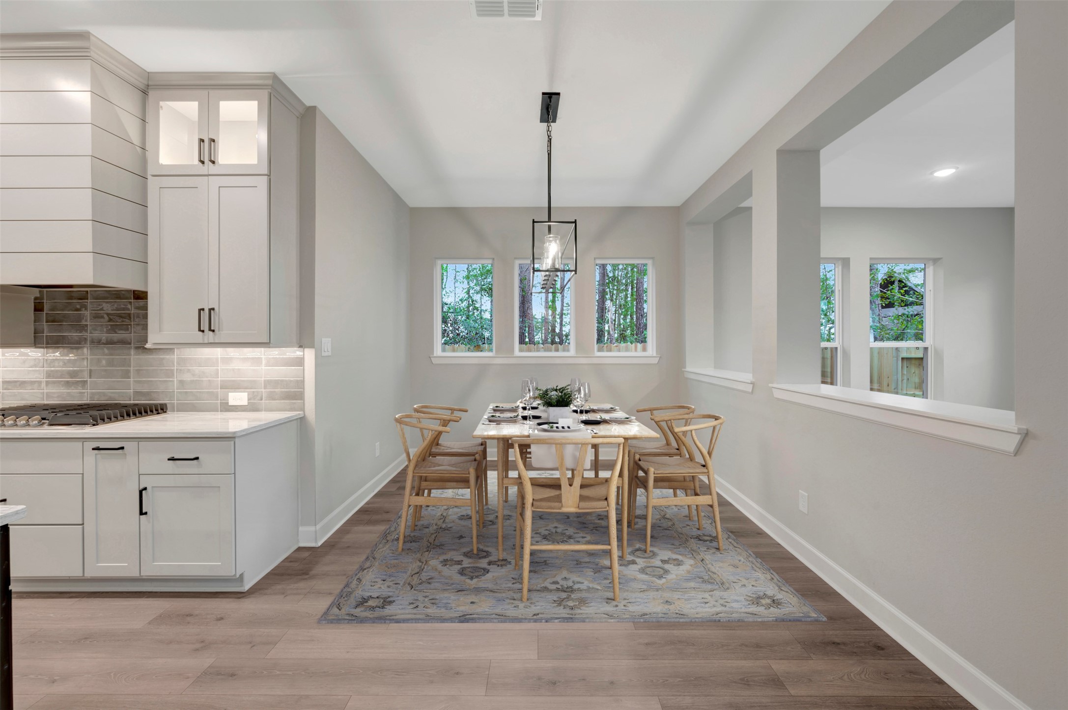 15722 Terracotta Terrace Conroe, TX 77302 - Photo 3 of 50 a view of a dining room with furniture window and wooden floor