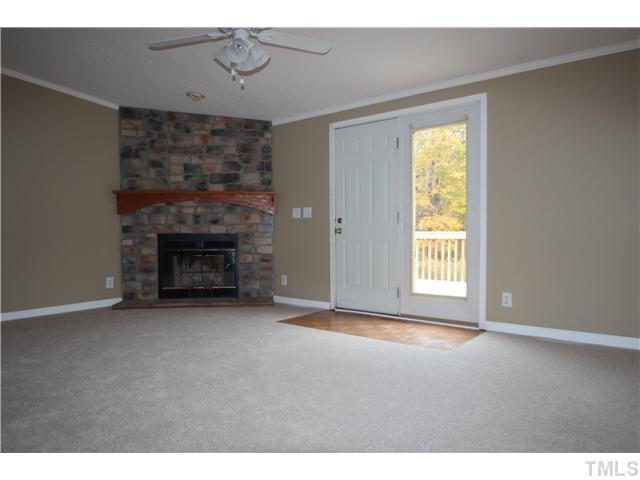 128 Northside View Roxboro, NC 27574 - Photo 2 of 15 Family room with stone fireplace and gas logs, ceiling fan