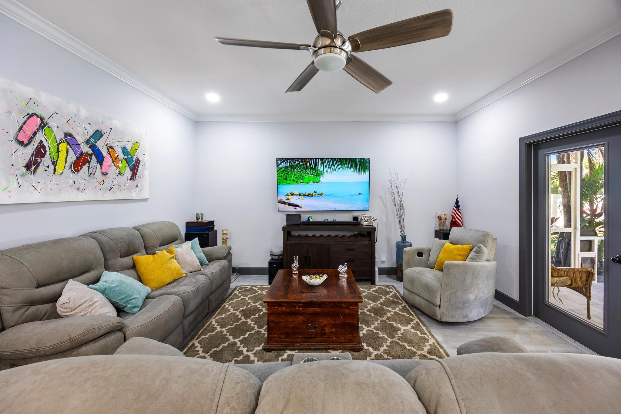 3337 Southwest Crestview Road Port St. Lucie, FL 34953 - Photo 12 of 86 a living room with furniture and a flat screen tv