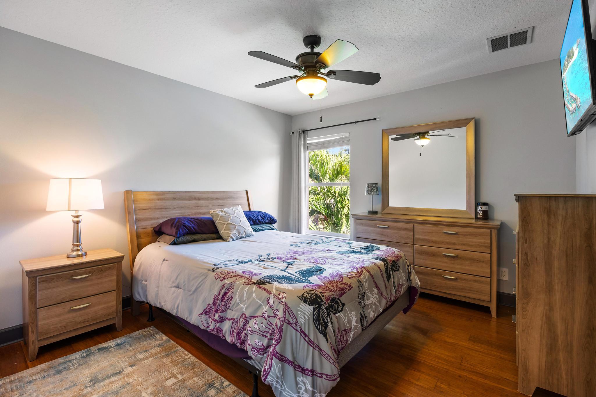 3337 Southwest Crestview Road Port St. Lucie, FL 34953 - Photo 29 of 86 a bedroom with a bed and a chandelier