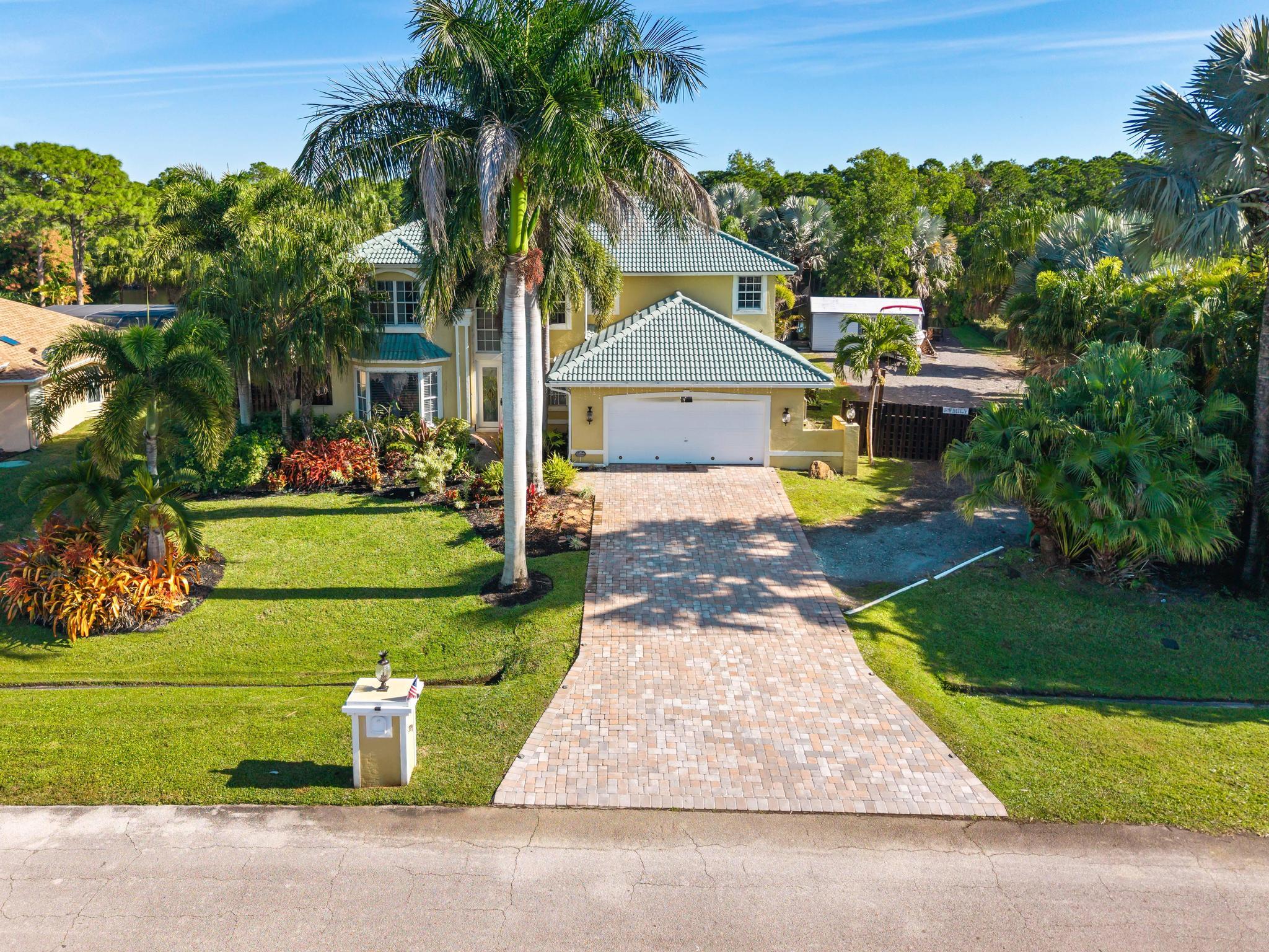 3337 Southwest Crestview Road Port St. Lucie, FL 34953 - Photo 3 of 86 a front view of a house with a yard and garage