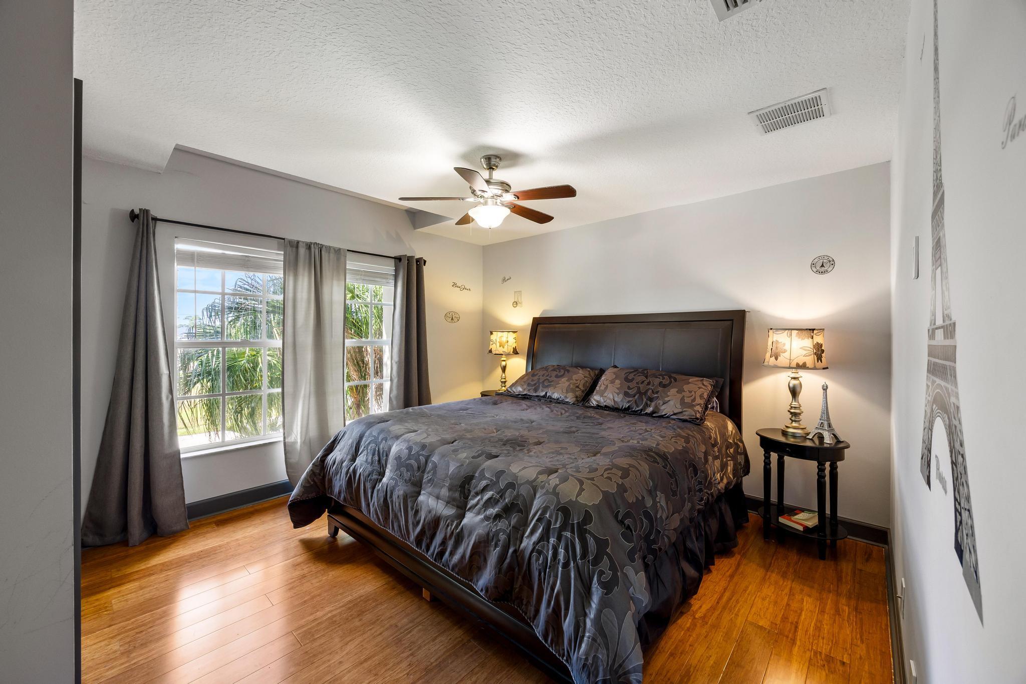 3337 Southwest Crestview Road Port St. Lucie, FL 34953 - Photo 33 of 86 a bedroom with a bed and a chandelier