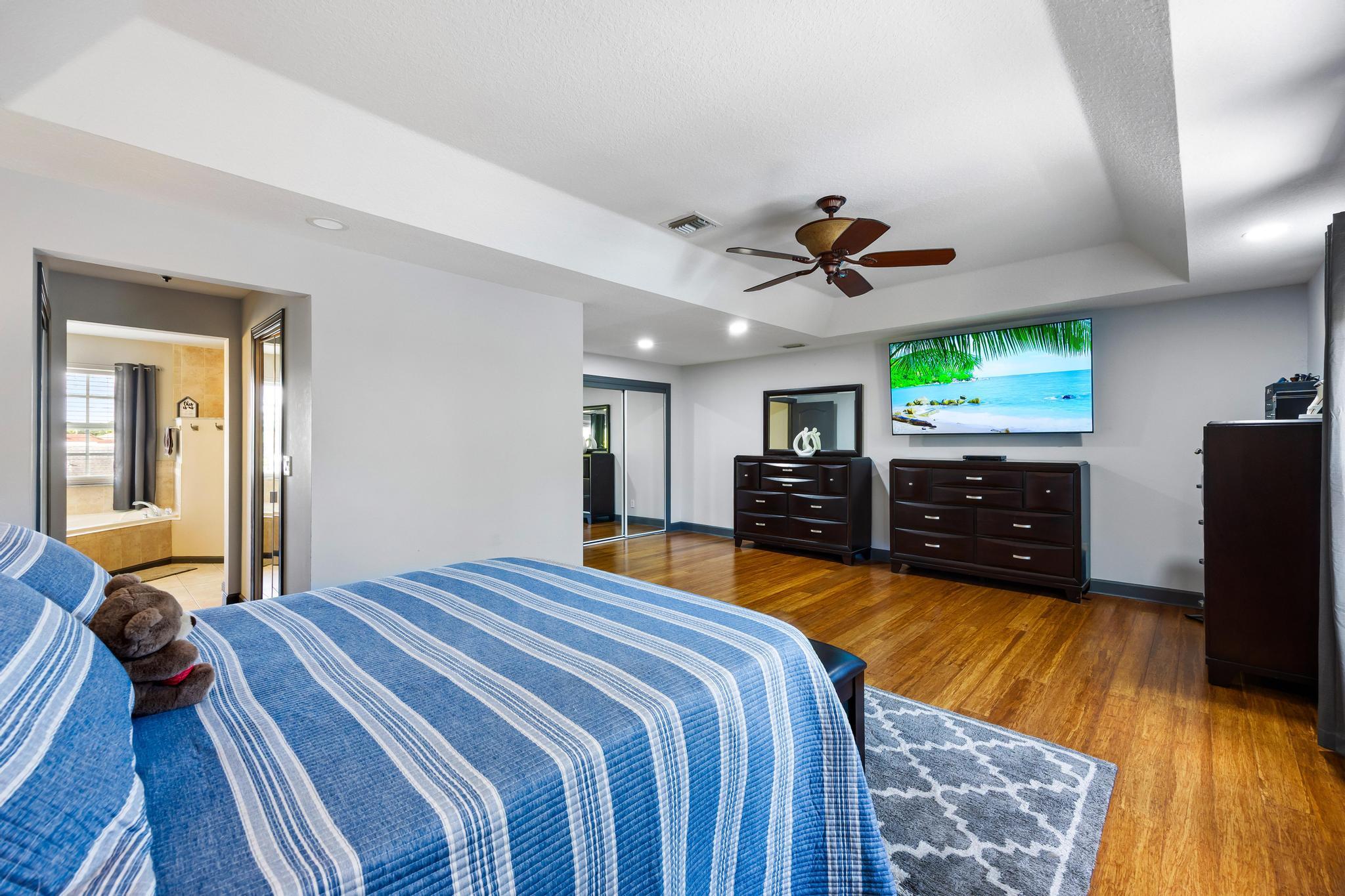 3337 Southwest Crestview Road Port St. Lucie, FL 34953 - Photo 39 of 86 a bed room with a bed and a chandelier