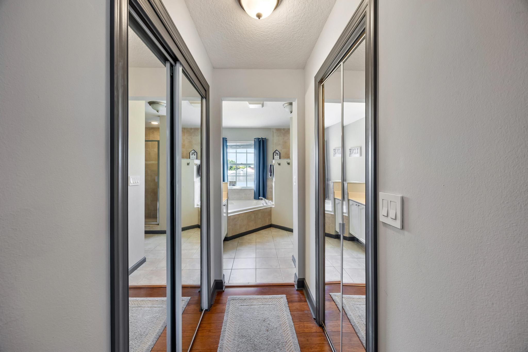 3337 Southwest Crestview Road Port St. Lucie, FL 34953 - Photo 40 of 86 a view of a hallway with bathroom and glass door