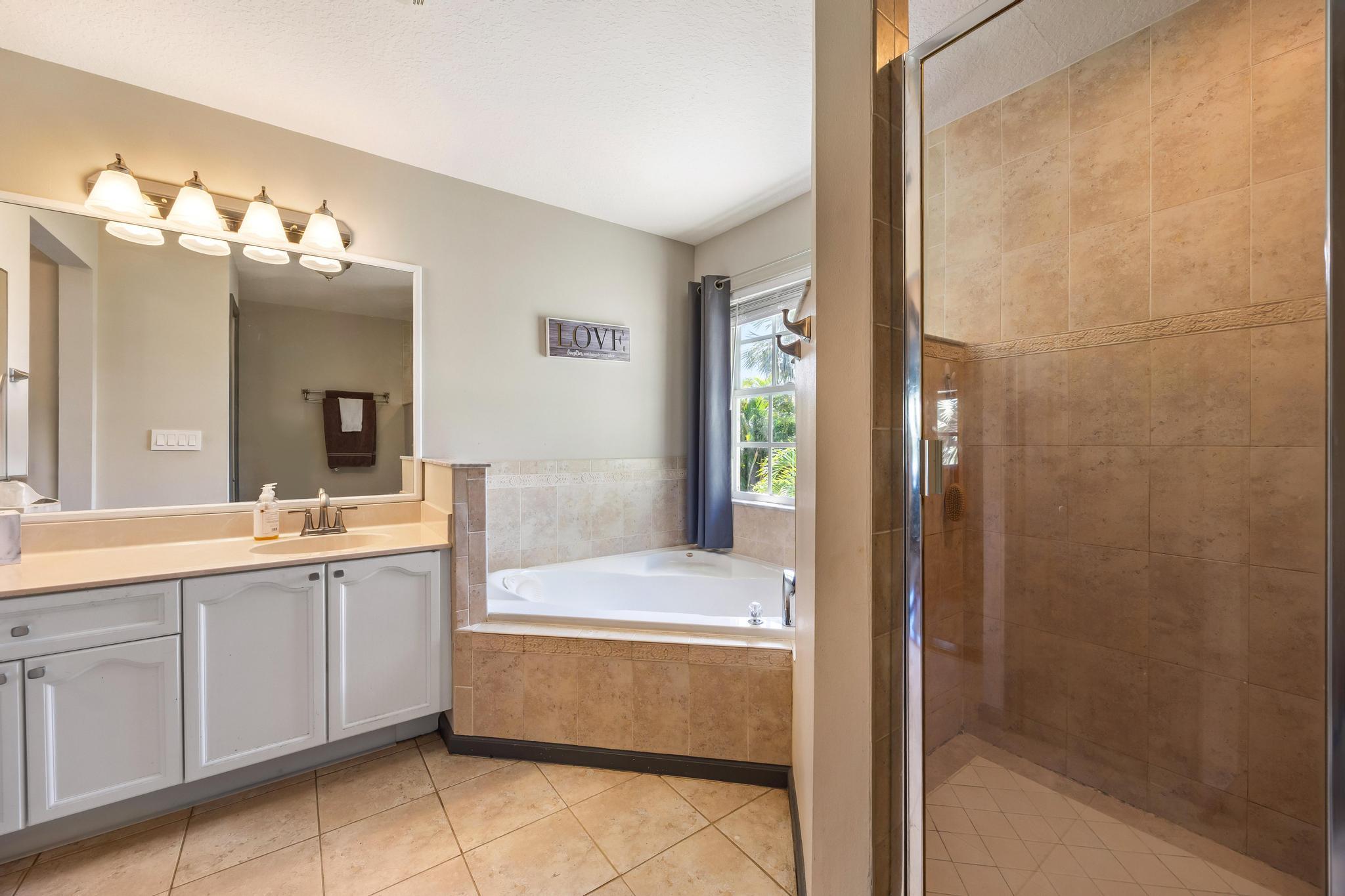 3337 Southwest Crestview Road Port St. Lucie, FL 34953 - Photo 44 of 86 a bathroom with a tub sink and mirror