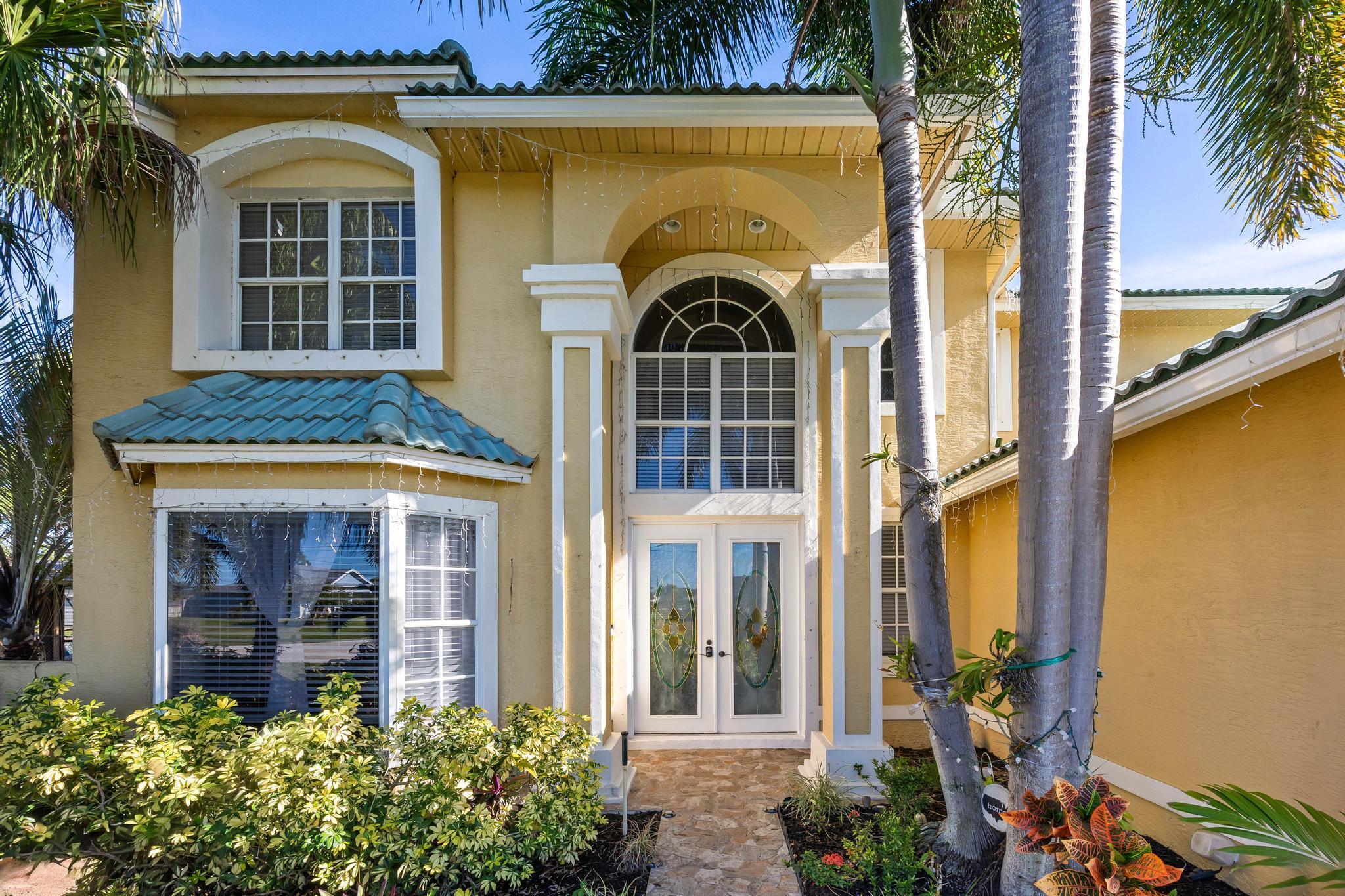 3337 Southwest Crestview Road Port St. Lucie, FL 34953 - Photo 5 of 86 a front view of a house with a yard