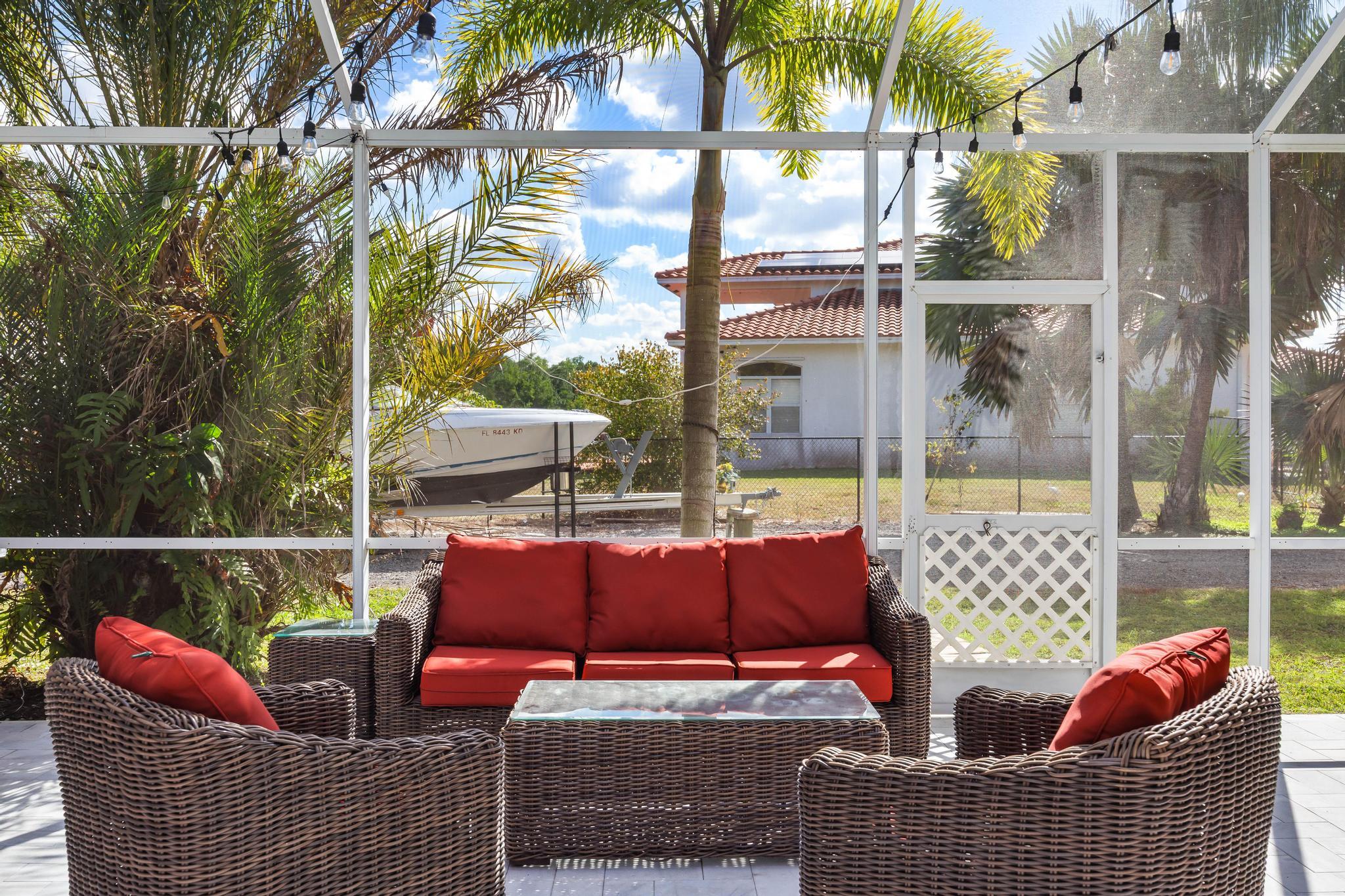 3337 Southwest Crestview Road Port St. Lucie, FL 34953 - Photo 52 of 86 a outdoor living space with patio furniture and a potted plant