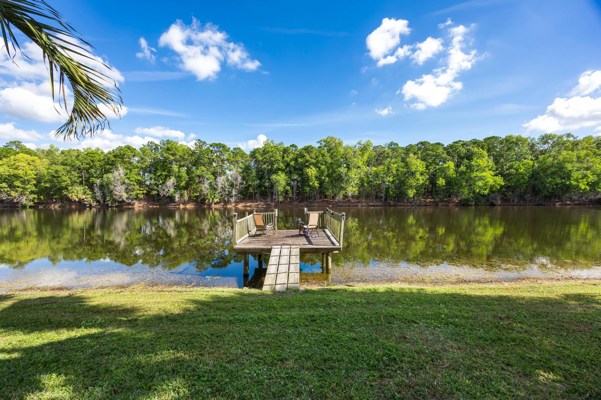 3337 Southwest Crestview Road Port St. Lucie, FL 34953 - Photo 64 of 86 a view of a lake with a big yard
