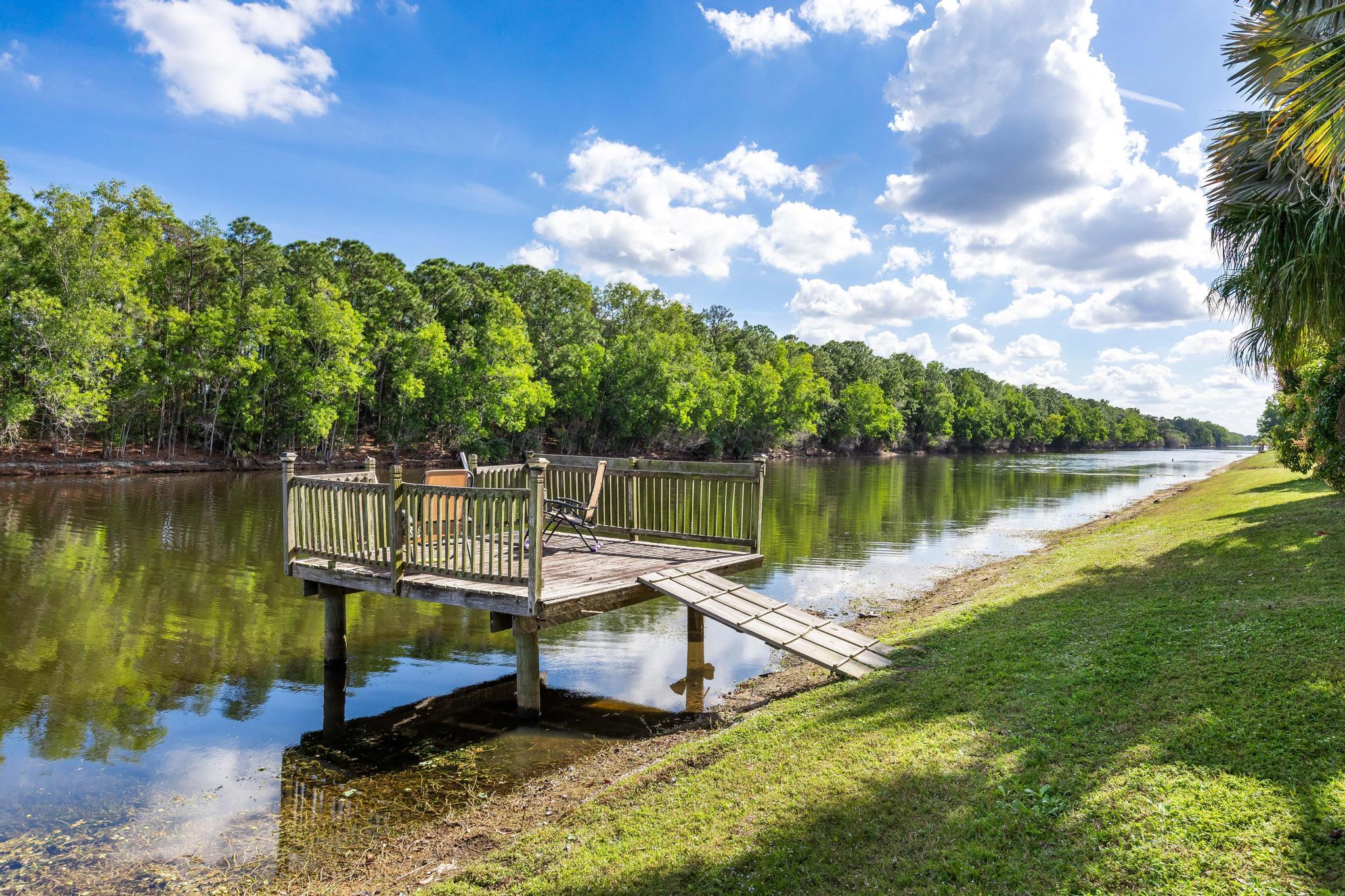 3337 Southwest Crestview Road Port St. Lucie, FL 34953 - Photo 67 of 86 a view of a lake with a house in the background