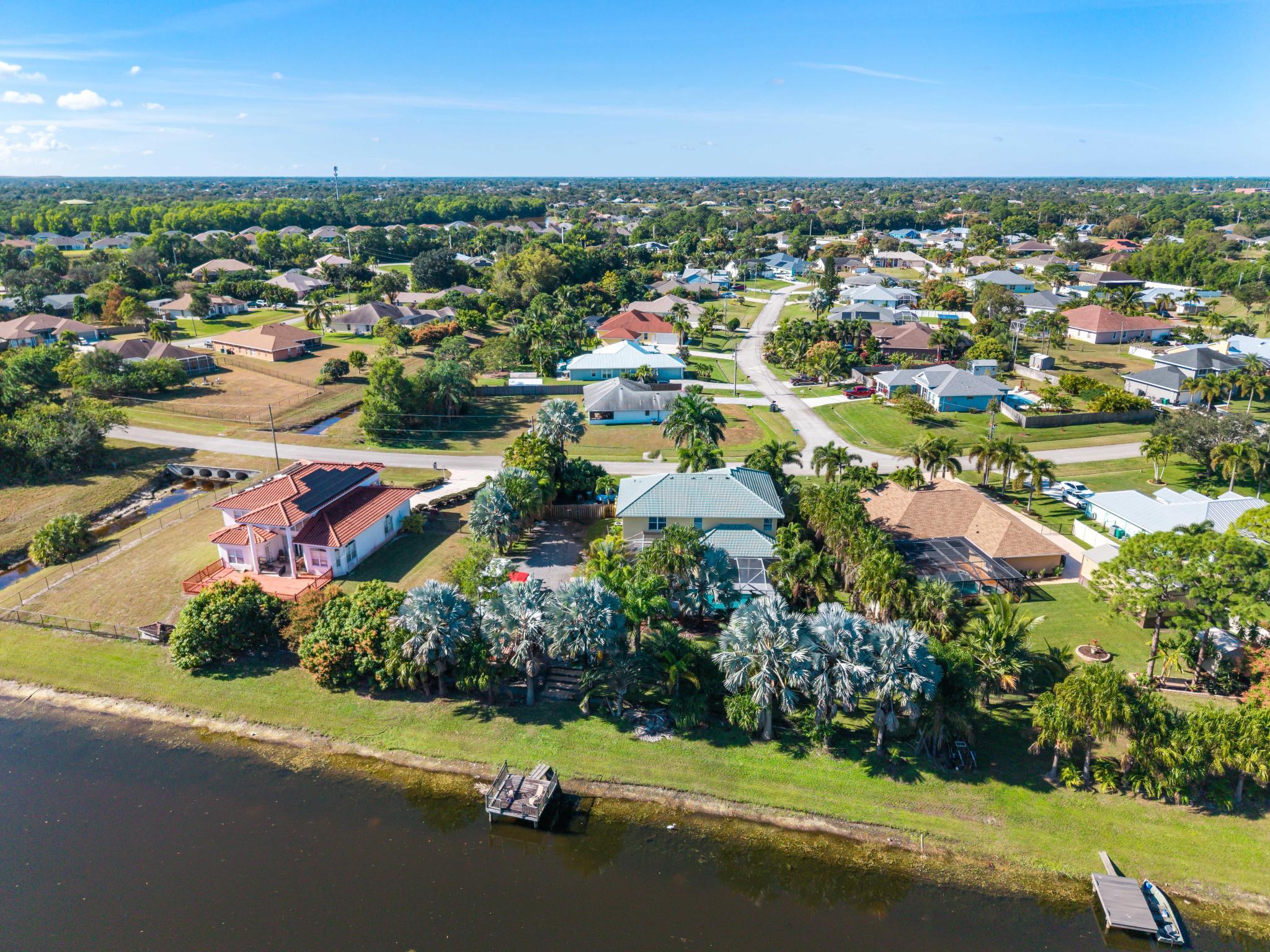 3337 Southwest Crestview Road Port St. Lucie, FL 34953 - Photo 71 of 86 an aerial view of residential houses with outdoor space and trees
