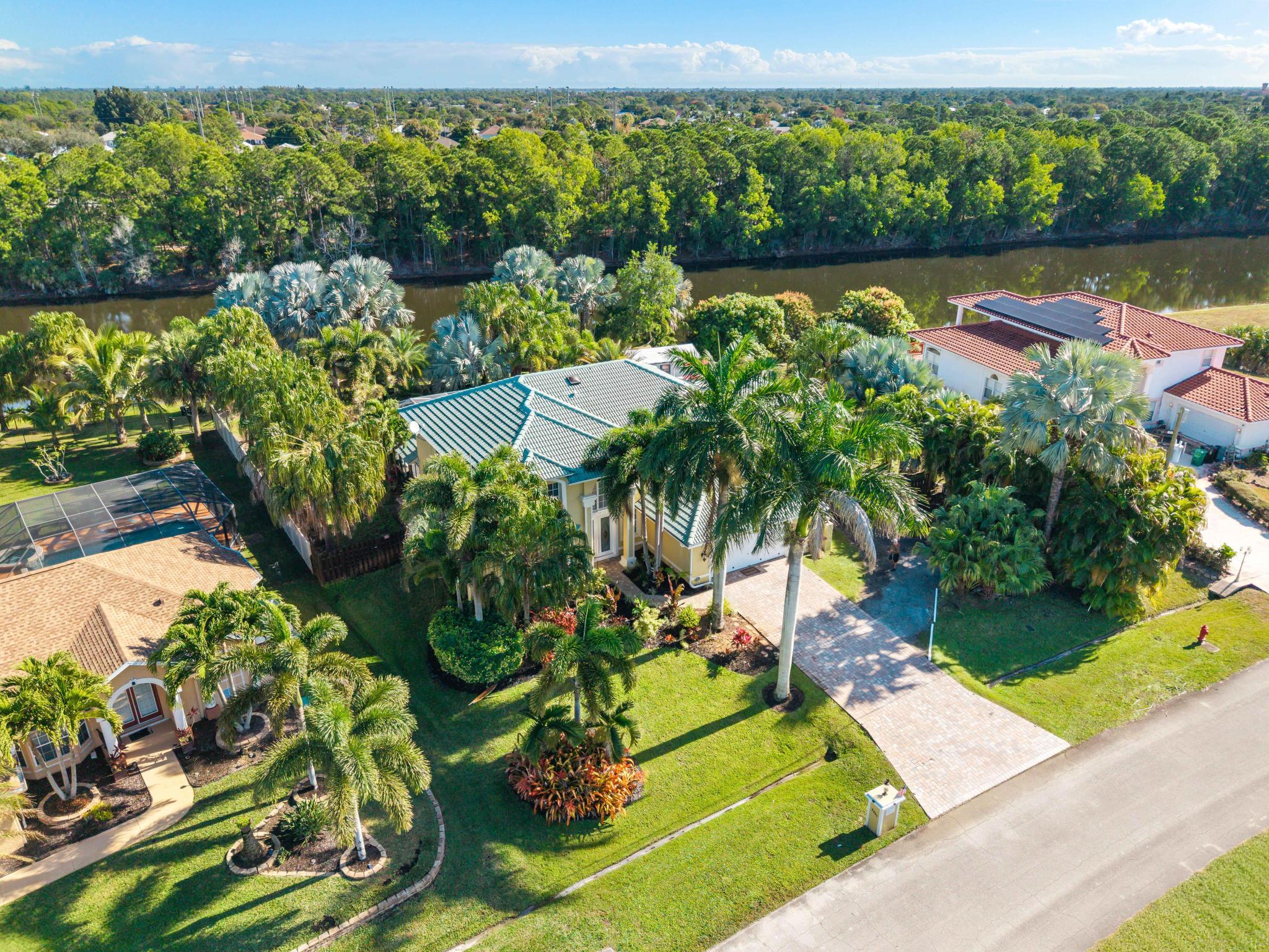3337 Southwest Crestview Road Port St. Lucie, FL 34953 - Photo 77 of 86 an aerial view of a house with a yard lake view and mountain view