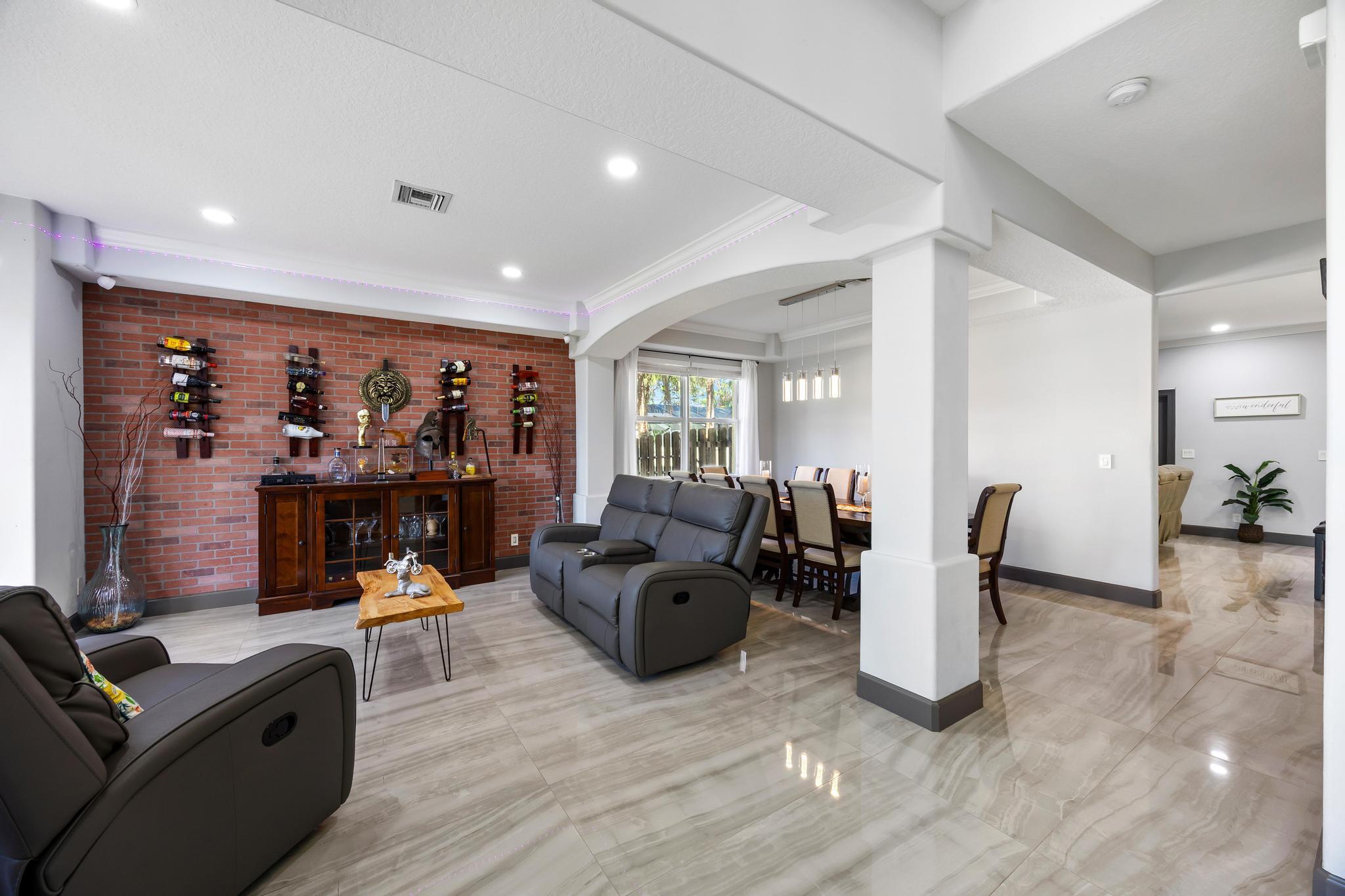 3337 Southwest Crestview Road Port St. Lucie, FL 34953 - Photo 8 of 86 a living room with furniture and a flat screen tv