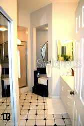 700 Starkey Road, Unit 223 Largo, FL 33771 - Photo 6 of 9 a bathroom with a tub sink and glass door