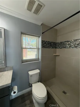 a white toilet sitting next to a bathroom sink