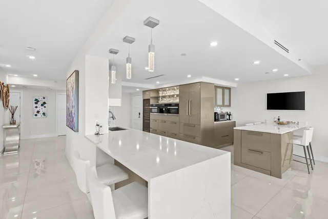a large kitchen with a large counter top appliances and cabinets