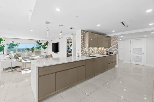 a large bathroom with a large mirror vanity and a sink