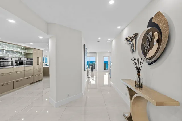 a spacious bedroom with a bed and a potted plant