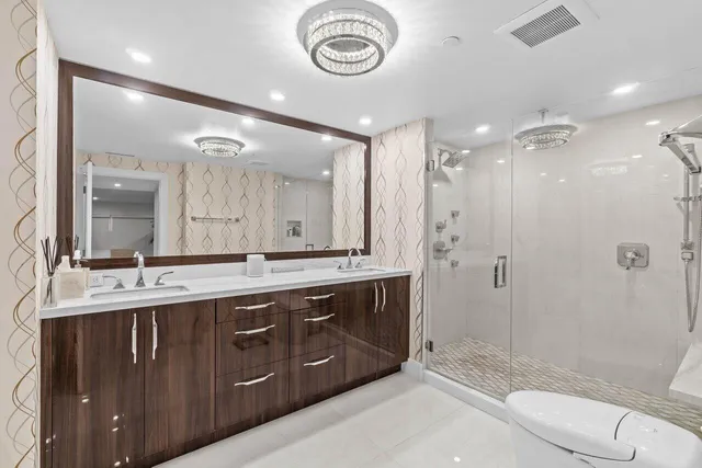 a bathroom with a double vanity sink a mirror and a bathtub