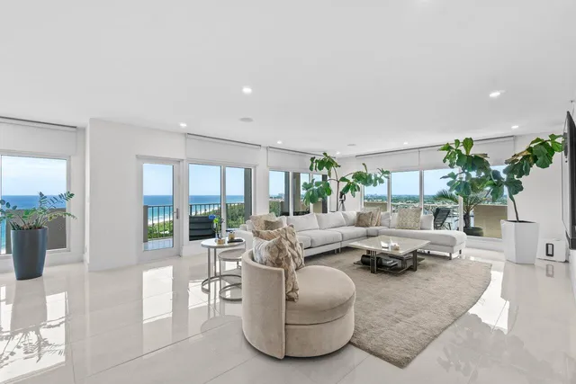 a living room with furniture and a floor to ceiling window