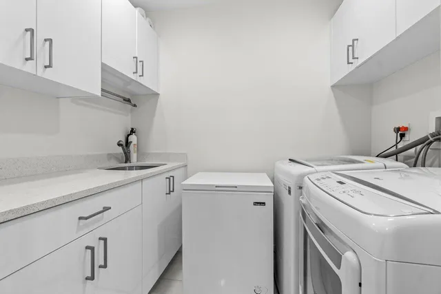 a bathroom with a granite countertop sink a toilet a mirror a bathtub and shower