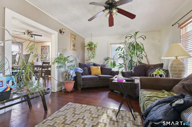 a living room with furniture and a wooden floor