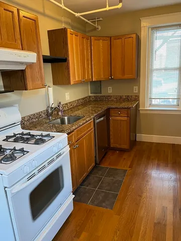 a kitchen with a stove a sink and a microwave